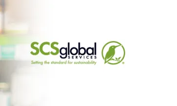 Shopper reading label of a jam jar and SCS logo on the right