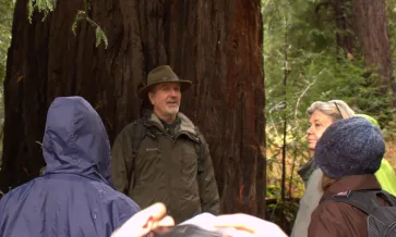 Group of people directing their attention to Robert Hrubes